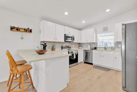 Chop and prepare your ingredients effortlessly with our kitchen's knife set, cutting board, blender, pots and pans, and various cooking utensils.