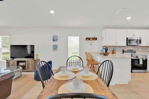 All the dishes, cups, and silverware are conveniently stored in the kitchen cabinetry, ready for you to enjoy your meals.