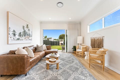 Living space flows onto level yard with sauna and cubby house