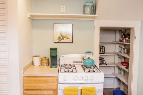 A fully stocked kitchen with pots, pans, plates, flatware, coffee and more. 