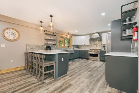 The kitchen has a microwave, dishwasher, and gas stove/oven.