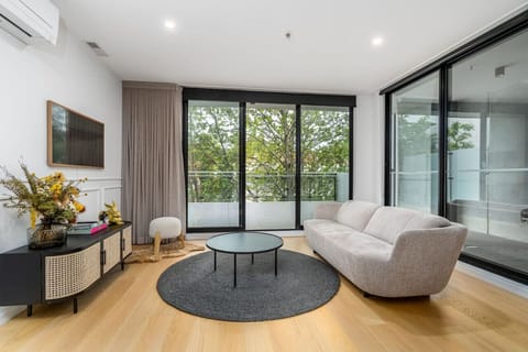 Chic living room with a large window for ample natural light.