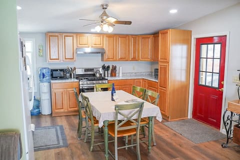 Kitchen highlights include seating for 6, a Keurig coffee machine with provided pods, a dishwasher, complimentary pure spring water dispenser, a microwave, a toaster oven, and plenty of various baking dishes, utensils, and spices.