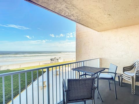 Spacious balcony offers comfortable seating and stunning views of the ocean, perfect for enjoying sunrises.