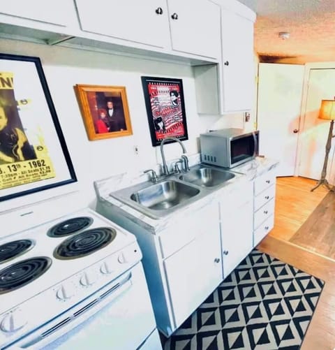 Kitchenette stocked with dishes, pans and utensils for your cooking needs.