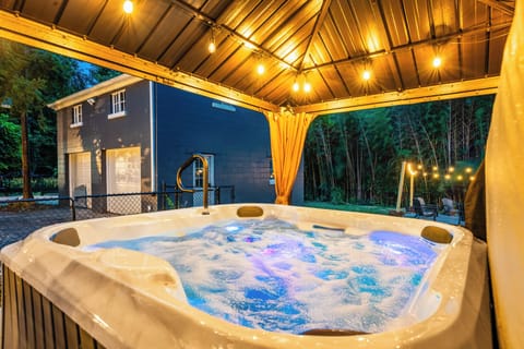 Relax year-round in the covered hot tub in the backyard
