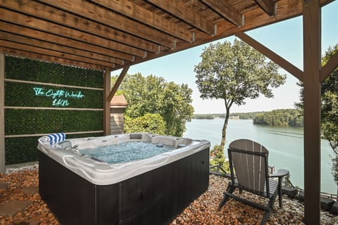 Relax in the year round heated hot tub overlooking the lake