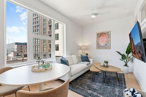 Beautifully designed living room. 65` TV, leather sofa and amazing views of mountains and city skyline.