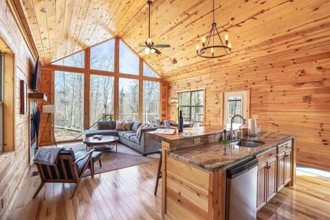 Living Room: Sun-soaked space with a sleek kitchen, perfect for gatherings and serene forest views!
