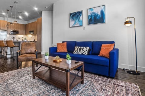 Bright and airy living room with plush seating, a large TV, and tasteful decor, creating the perfect space for relaxation and entertainment.