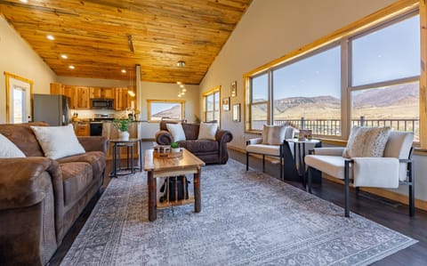 Our spacious living room is perfect for relaxing after a day of adventure, featuring large windows that let in plenty of natural light and breathtaking views.