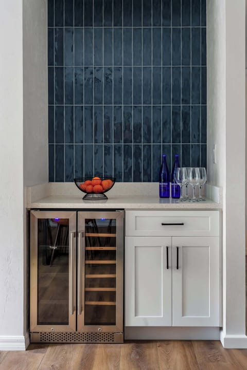 A sophisticated corner for the modern traveler. Features premium wine storage, a striking vertical tile feature, and everything you need to serve up drinks in style.
