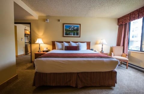 Spacious bedroom with a comfortable bed and ample natural light for a restful stay.