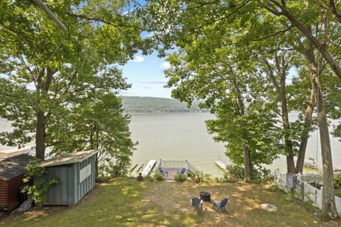 Peaceful lakefront view at Willow Beach, Honeoye, NY—perfect for enjoying a cozy fire by the water with stunning nature all around. 