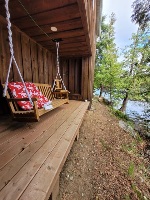 Comfortable seating on the porch swing chair by the edge of the lake