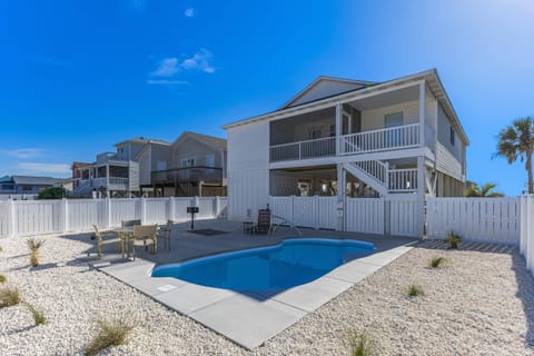 Exterior view of the home, featuring a spacious and fenced yard.