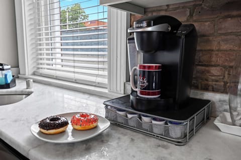 Kitchen: Marble countertops, sleek appliances, and exposed brick – your perfect cooking haven awaits!