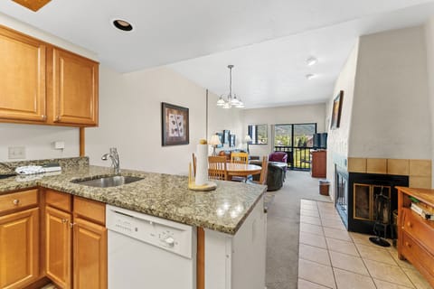Your fully equipped kitchen flows seamlessly into the cozy living space, complete with granite countertops and a warming fireplace for memorable evenings.