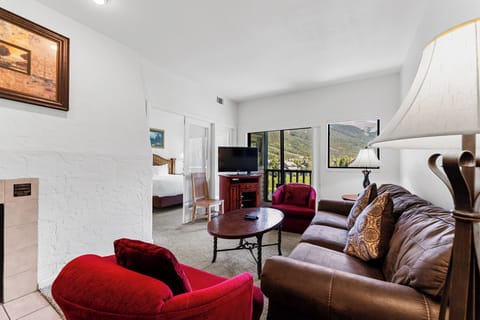 Unwind in this cozy living room where plush seating and mountain views create your perfect retreat.