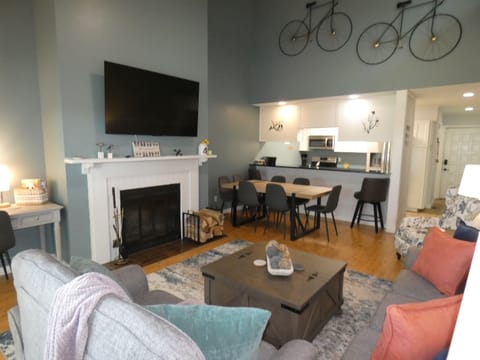 Big Living room with wood fireplace and big screen tv.