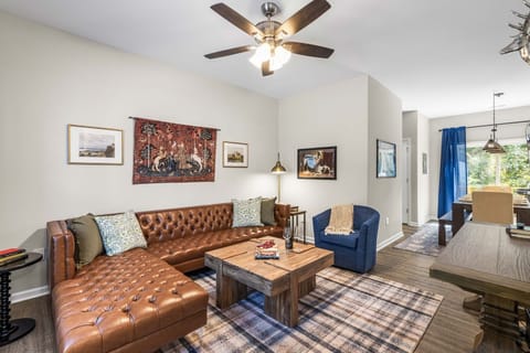 Living room with ceiling fan, large leather couch