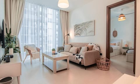 Relax in this cozy living room filled with natural light, complete with a smart TV, comfy seating, and stylish décor. A perfect spot to unwind after a day of exploring.