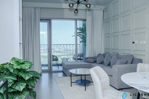 Cozy living room with a plush sofa and large windows offering incredible city views