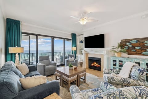Unwind in this cozy oceanfront living room where your ceiling fan keeps you comfortable while you enjoy the sea breeze and fireplace ambiance.