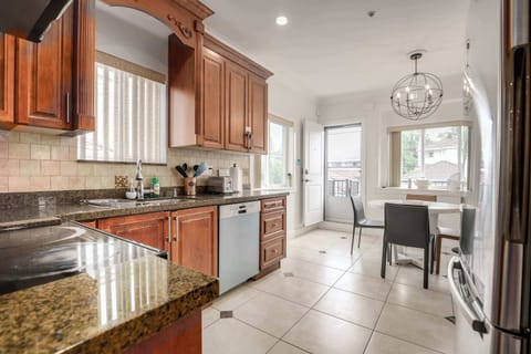 Fully equipped kitchen featuring stainless steel appliances and a cozy dining area, providing everything you need for home-cooked meals.