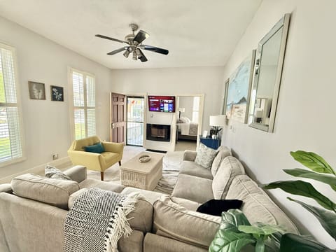 Living Room - The coffee table and chair can be moved in order to fit the queen air mattress that we provide.