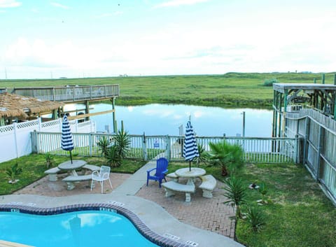 Relax by the pool and soak in serene canal views