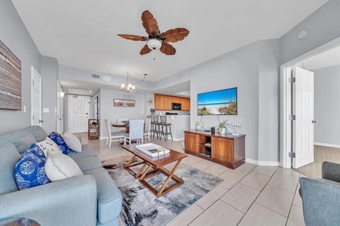 Living room with huge TV and sofa bed (sleeps 2) and access to balcony