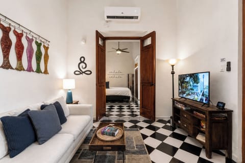 Comfortable living area with A/C, Smart TV, and a full sofa that can sleep one.