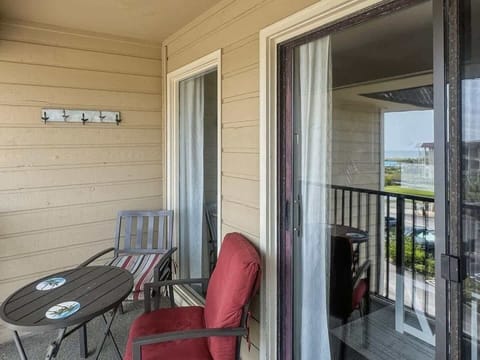 Enjoy the fresh air on the private shaded balcony, furnished with a patio table.