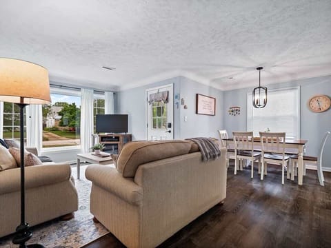 Natural light floods the living room, creating a warm and welcoming atmosphere.