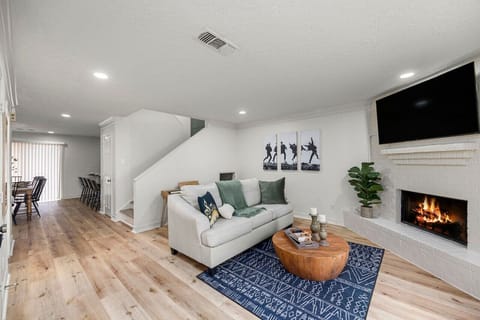 Warm, inviting living room with fireplace and smart TV