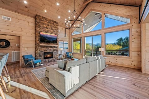 The stunning living room includes large windows with mountain views and access to the private back deck.