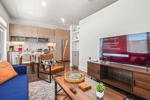 You feel at home as you settle into the living room, where the inviting atmosphere is perfect for lounging or entertaining.