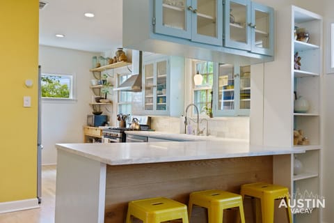 Colorful full kitchen with all the essentials including bar seating and dishwasher!