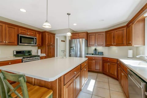 Spacious cooking space with island and rich wood cabinets