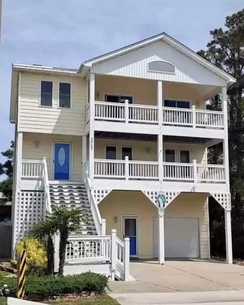 Three-story, bay-facing beach house with two-covered decks 