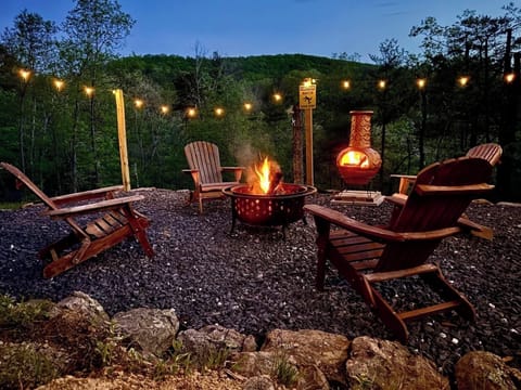Relax as the sun sets over the mountains - fire pit warmth included!