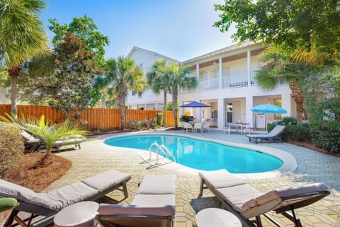Dive into your own tropical paradise with this sparkling pool surrounded by swaying palms and comfortable loungers for ultimate relaxation.