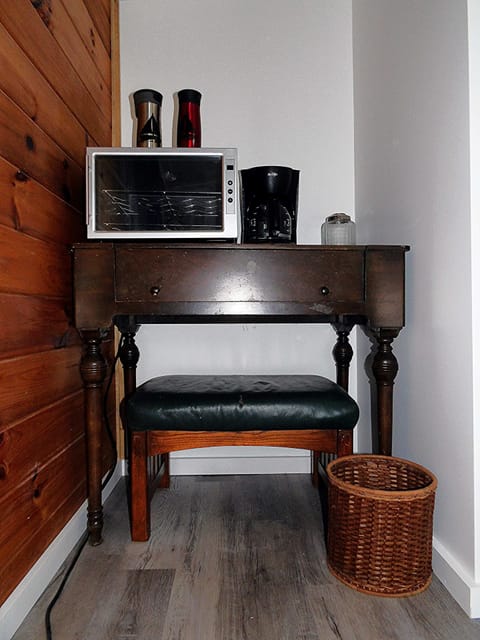Primary bedroom with micro fridge and small coffee pot.