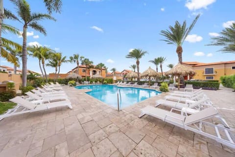 Swimming pool surrounded by pool chairs.