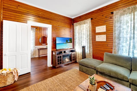 Living room with smart TV, electric fireplace, and full sectional couch.