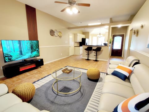 75" smart TV and an electric fireplace in the living room