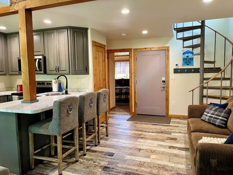 Bathroom and main bedroom off to the left, spiral staircase leads to the loft