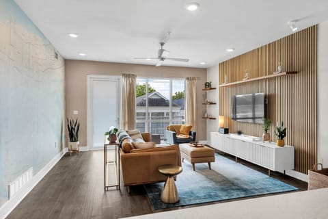 Bright and modern living room with a cozy leather sofa and New Orleans-inspired decor