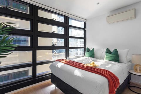 The master bedroom with a queen sized bed & plush pillows.